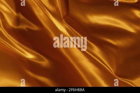 Abstrakter Hintergrund Gold Seide oder Satin Luxus Stoff Textur Stockfoto