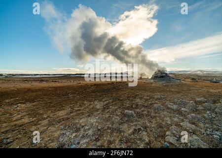 Namafjall Hverir Geothermiegebiet in Island. Atemberaubende Landschaft von Schwefel Tal mit rauchenden Fumarolen und blau bewölkten Himmel, Reise Hintergrund Stockfoto