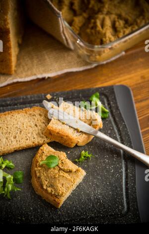 Hausgemachte Fleischpastete mit hausgemachtem Brot auf einem Holztisch Stockfoto