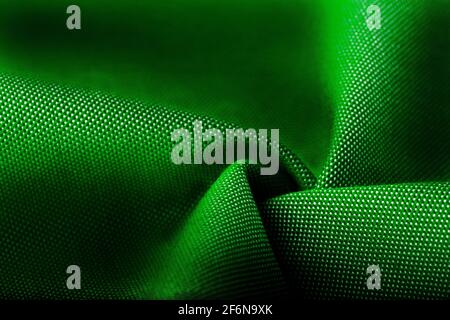 Textur, Hintergrund, Vorlage. Seide andere Baumwolle Stoff grüne Farbe, Seide andere Baumwolle Vorhänge. In Nahaufnahme, Fäden aus Stoff und ein Muster von Textur Stockfoto