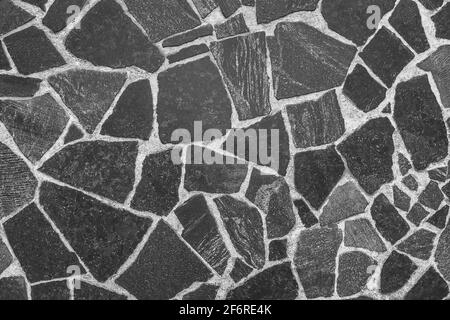 Schwarze abstrakte Muster Steinplatten Boden, dunkle Mosaikfliesen Textur Wand grauen Hintergrund. Stockfoto