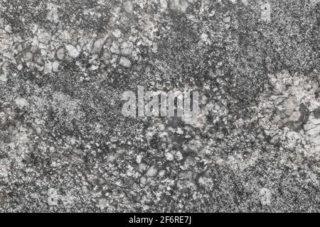 Dunkelgrauer Granit oder alte Marmorplatten mit abstrakter Wandstruktur im Hintergrund. Stockfoto