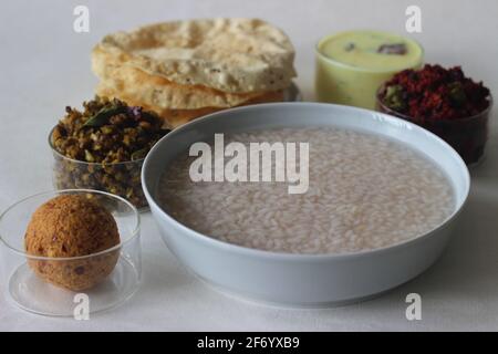 Reisbrei oder Kanji zusammen mit Kokosnuss-Chutney, Rote-Beete-Kartoffel-Thoran, gebratenem Moong, gebratenem Papad und gehärteter Buttermilch. Eine Lieblingsmahlzeit von Stockfoto