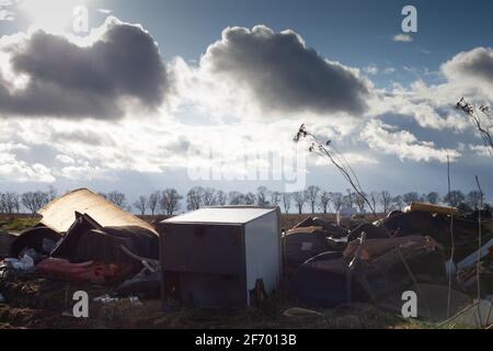 Poznan, Polen - 02. April 2021: Bau- und Hausmüll in einer illegalen Mülldeponie auf einer Räumung. Kriminelle Umweltverschmutzung der Wildnis Stockfoto