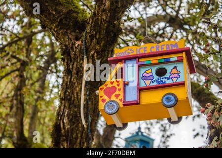 Vancouver, British Columbia, Kanada - 23. September 2017: Die gelbe Vogelhaus-Form eines Autos auf einem Baum im Frühlingswald Hintergrund Stockfoto