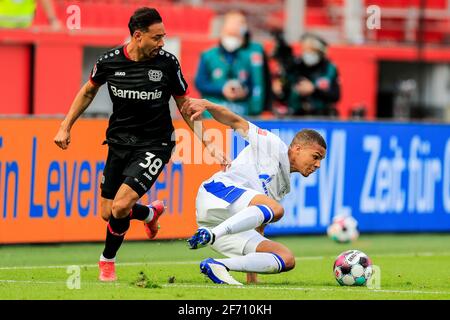 Leverkusen. April 2021. Karim Bellarabi (L) aus Leverkusen steht mit Malick Thiaw von Schalke 04 während eines Bundesliga-Fußballspiels zwischen Bayer 04 Leverkusen und dem FC Schalke 04 in Leverkusen, Deutschland, am 3. April 2021 vor. Quelle: Xinhua/Alamy Live News Stockfoto