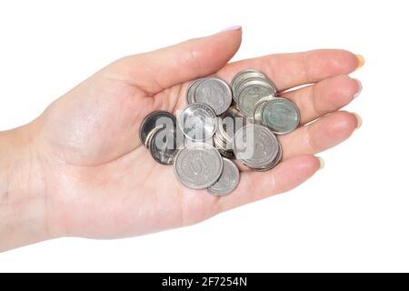 Frauenhand mit ukrainischen Münzen isoliert auf weißem Hintergrund. Stockfoto