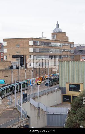 Straßenbahnen, die am Contemporary in Nottingham City vorbeifahren, aufgenommen vom Dach des neuen Nottingham College City Hub, Nottinghamshire, England Stockfoto