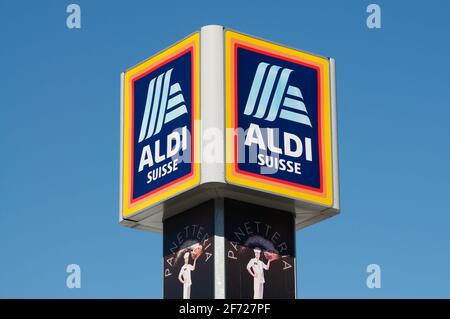 Giubiasco, Schweiz - 20. März 2021 : Aldi Suisse Schild hängt oben auf einem Geschäft in Giubiasco. ALDI ist ein deutsches Unternehmen und einer der großen Stockfoto