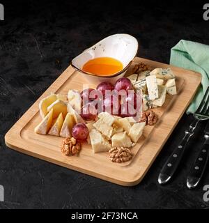 Käse mit Obst und Trauben Stockfoto
