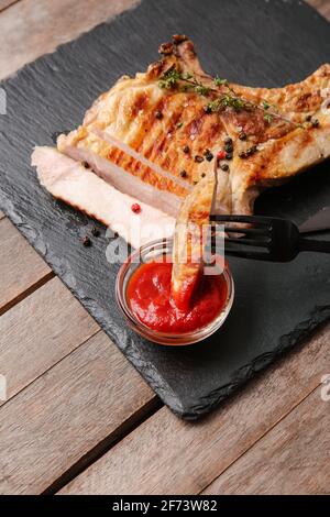 Leckeres Steak mit Sauce auf Holzboden Stockfoto