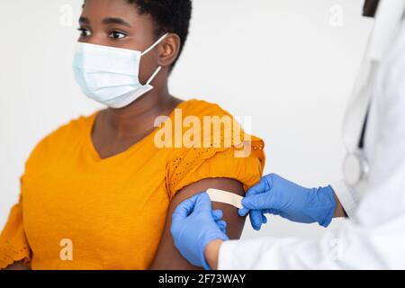 Afroamerikanische Frau, Die Gegen Covid-19 Geimpft Wird, Weißer Hintergrund, Abgeschnitten Stockfoto