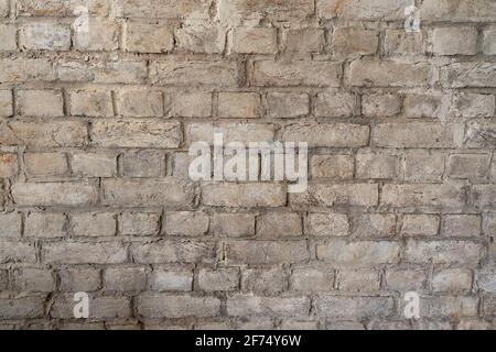 Alte graue Ziegelmauer. Steinhintergrund. Stockfoto