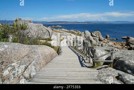 Spanien, Galizien, Holzpfad entlang der Küste mit Granitfelsen, Atlantik, Provinz Pontevedra, San Vicente do Grove Stockfoto