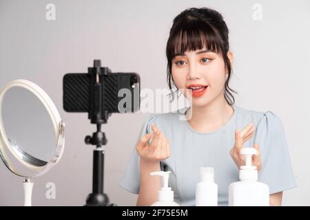 Junge asiatische Frau live Streaming zu lehren Make-up online Stockfoto