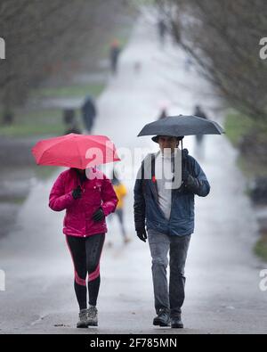 30/01/2021. London, Großbritannien. Mitglieder des öffentlichen Schutzgebietes unter Regenschirmen während einer Regendusche im Greenwich Park . In Teilen Großbritanniens sind gelbe Wetterwarnungen für Regen und Schnee vorhanden. Bildnachweis: George Cracknell Wright Stockfoto