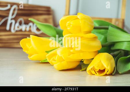 Bouquet von gelben Tulpen auf einer hölzernen Oberfläche, Farbe des Jahres 2021 Stockfoto