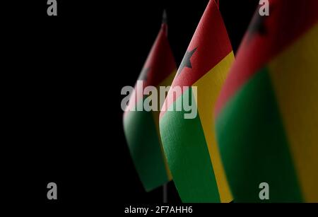 Kleine Nationalflaggen der Guinea-Bissau auf einem schwarzen Hintergrund Stockfoto