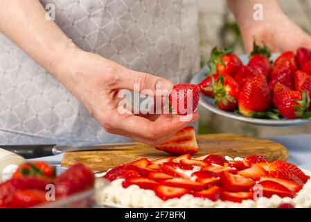 Der Koch verschönert das köstliche Dessert mit frischem Erdbeer- und Erdbeerkuchen. Stockfoto