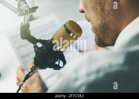 Business Podcast, Online-Seminar. Geschäftsmann spricht im Mikrofon Stockfoto