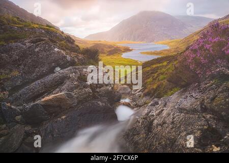 Dramatische Landschaft am Cwm Idwal in den Gyderau-Bergen des Snowdonia National Park in Nordwales bei Sonnenuntergang oder Sonnenaufgang. Stockfoto