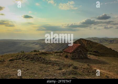 Massiver Garedjian Ridge in Georgia in der Nähe des David Gareji Klosters. Häuser oder Kirchen im Vordergrund. Atemberaubende Aussicht vom David Gareja Kloster Stockfoto