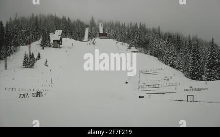 Panoramablick auf verlassene Schanzen auf dem Berg Igman in Ilidza, Austragungsort der olympischen Spiele 1984. Neblig und neblig Panorama der alten Schanzen. Stockfoto