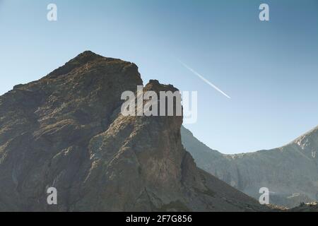 Landschaftsfotografie der einsamen steilen Berge im Sommer, unter einem riesigen blauen Himmel Streifen von der weißen Spur eines fernen Flugzeug, Aragonese Pyren Stockfoto