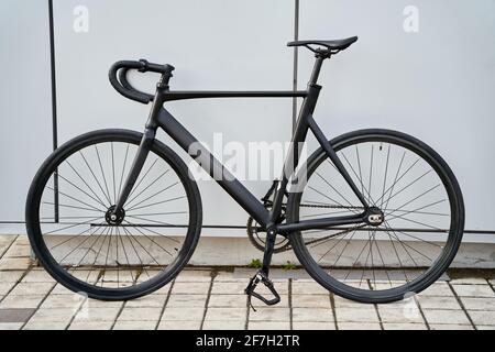 Schwarzes Stadtfahrrad gegen graue Mauer in der Stadt Stockfoto