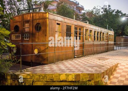 Alte Holzkutschen parkten nachts als Ausstellung von Eisenbahnen im Freien in einem Park in der griechischen Stadt Kalamata. Freilufteisenbahnmuseum in griechenland Stockfoto