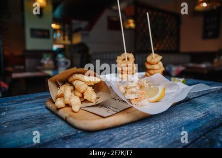 Snacks zu Bier im Teig auf einem blauen Hintergrund aus Holz. Stockfoto