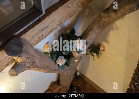 Baumstamm Dekoration mit Blumen in einem Holzhaus. Stockfoto