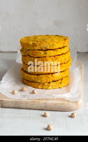 Im Ofen gebackene Kichererbsen-Koteletts. Enthält Karotten, Zwiebeln, Knoblauch. Veganes Lebensmittelkonzept. Vertikale Ausrichtung. Stockfoto