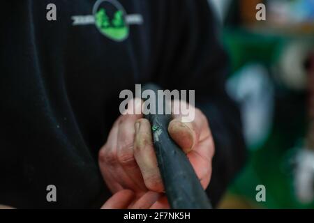 Berlin, Deutschland. März 2021. Im Fahrradladen 'du und ich' in Berlin entfernt Mechaniker Tim ein Stück Glas aus einem Fahrradschlauch. Quelle: Gerald Matzka/dpa-Zentralbild/ZB/dpa/Alamy Live News Stockfoto