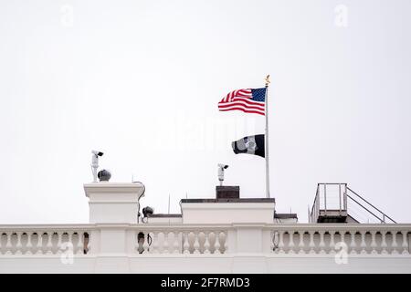 Washington, DC, USA. April 2021. Am Freitag, den 9. April, werden im Weißen Haus in Washington, DC, USA, eine amerikanische Flagge und eine Kriegsgefangenenflagge gezeigt. 2021. Es wird erwartet, dass die USA ihre Wind- und Solarkapazität in den nächsten 10 Jahren fast verdreifachen werden, aber das wird immer noch nicht ausreichen, um das Ziel von Präsident Biden, das Stromversorgungssystem des Landes bis 2035 vollständig zu entkarbonisieren, zu erreichen. Quelle: Stefani Reynolds/Pool via CNP, weltweite Nutzung Quelle: dpa/Alamy Live News Stockfoto