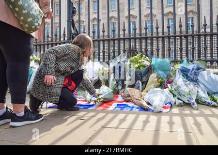 London, Großbritannien. April 2021. Ein Mädchen legt Blumen zu Ehren von Prinz Philip vor dem Buckingham Palace. Der Herzog von Edinburgh starb heute im Alter von 99 Jahren. Kredit: Vuk Valcic/Alamy Live Nachrichten Stockfoto