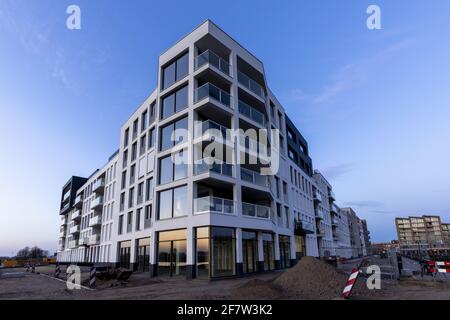 ZUTPHEN, NIEDERLANDE - Mar 30, 2021: Scharfe Linien des modernen Luxus-Apartment-Gebäudes aus einer Baustelle Stockfoto