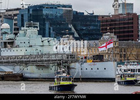 London, Großbritannien. April 2021. Während des Gewehrsalutes 41 am Tower of London stehen Boote der River Police auf dem Bahnhof, um den Verkehr auf der Themse zu stoppen. Der Weiße Ensign fliegt auf der HMS Belfast zu Ehren von Prinz Philip, Herzog von Edinburgh, der gestern im Alter von 99 Jahren starb, auf halber Höhe. Kredit: Guy Bell/Alamy Live Nachrichten Stockfoto