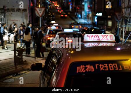 Hongkong, November 2019: Taxi-Autos im Nachtleben von Hongkong bei Nacht Stockfoto