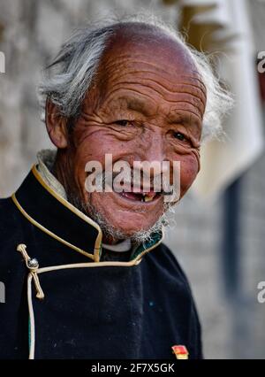 (210410) -- LHASA, 10. April 2021 (Xinhua) -- Dawa Gokye posiert für ein Foto im Dorf Gyadu der Gemeinde Jangra im Kreis Gyangze der Stadt Xigaze, südwestlich der Autonomen Region Tibet, 22. März 2021. Dawa Gokye, 76, einst Leibeigene in einem lokalen Herrenhaus Tibets, lebte bis zur demokratischen Reform 1959 in Hoffnungslosigkeit und Verzweiflung. In den Augen der Leibeigenen sind Leibeigene nichts anderes als "sprechende Werkzeuge", die ihnen ausgeliefert sind. Dawa erinnerte sich, dass sein Kopf vom Verwalter des Herrenhauses schwer verletzt wurde, da der damals 8-Jährige das Wasser beim Brühen des Tees nicht heiß kochte. Zusammen mit Zehntausenden von o Stockfoto