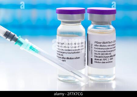 Calgary, Alberta, Kanada. 8. April 2021. Ein paar Pfizer-Dosen von Covid-19-Impfstoffen auf Fläschchen und einer Injektionsspritze. Stockfoto
