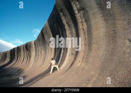 Westaustralien. Katanning. Junger Mann, der auf dem Wave Rock in der Nähe von Hyden steht. Stockfoto