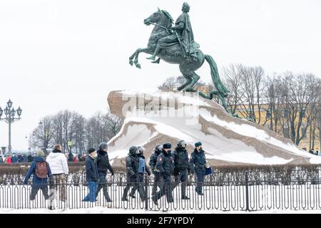 Eine Gruppe von diensthabenden Polizisten, die am Bronze Horseman, der Statue von Peter dem Großen auf dem Senatsplatz, St. Petersburg, Russland, vorbeigehen Stockfoto