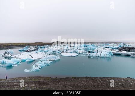 Panoramablick auf Eisblöcke, die im Wasser schwimmen Ein sehr wolkiger Tag Stockfoto