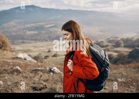 Rothaarige Frau in Jacke mit Rucksack reisen Wandern Berge frisch Luft Stockfoto