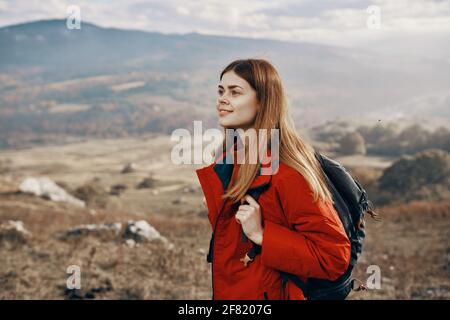 Rothaarige Frau in Jacke mit Rucksack reisen Wandern Berge frisch Luft Stockfoto
