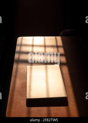 Büro zu Hause mit IT-Ausrüstung und Online-Kommunikation. Arbeiten von zu Hause aus und Fernzugriffskonzept. Selektiver Fokus und Sonnenlicht auf IT-Ausrüstung Stockfoto