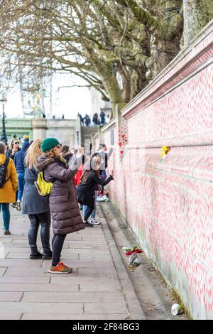 11. April 2021, London, Großbritannien - eine Frau fotografiert die National COVID Memorial Wall entlang der South Bank Stockfoto