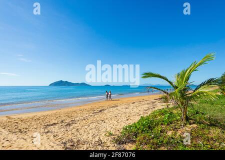 Zwei Personen, die am Strand von Wongaling, Mission Beach, Queensland, QLD, Australien, spazieren gehen Stockfoto