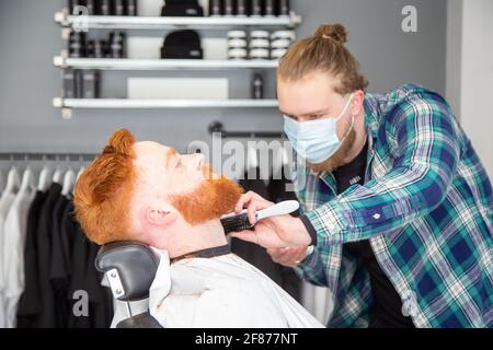 Halesowen, West Midlands, Großbritannien. April 2021. Firmenchef Rhys Barrett, 27, lässt sich von Sam Whitlock, Miteigentümer von Label Male Image in Halesowen, West Midlands, die Haare schneiden, da sich heute nach der Lockerung der Covid-Beschränkungen die Barber öffnen. Kredit: Peter Lopeman/Alamy Live Nachrichten Stockfoto